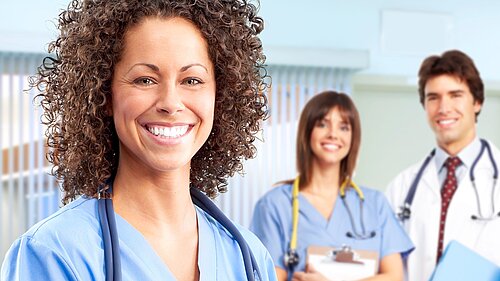 Three doctors smiling.
